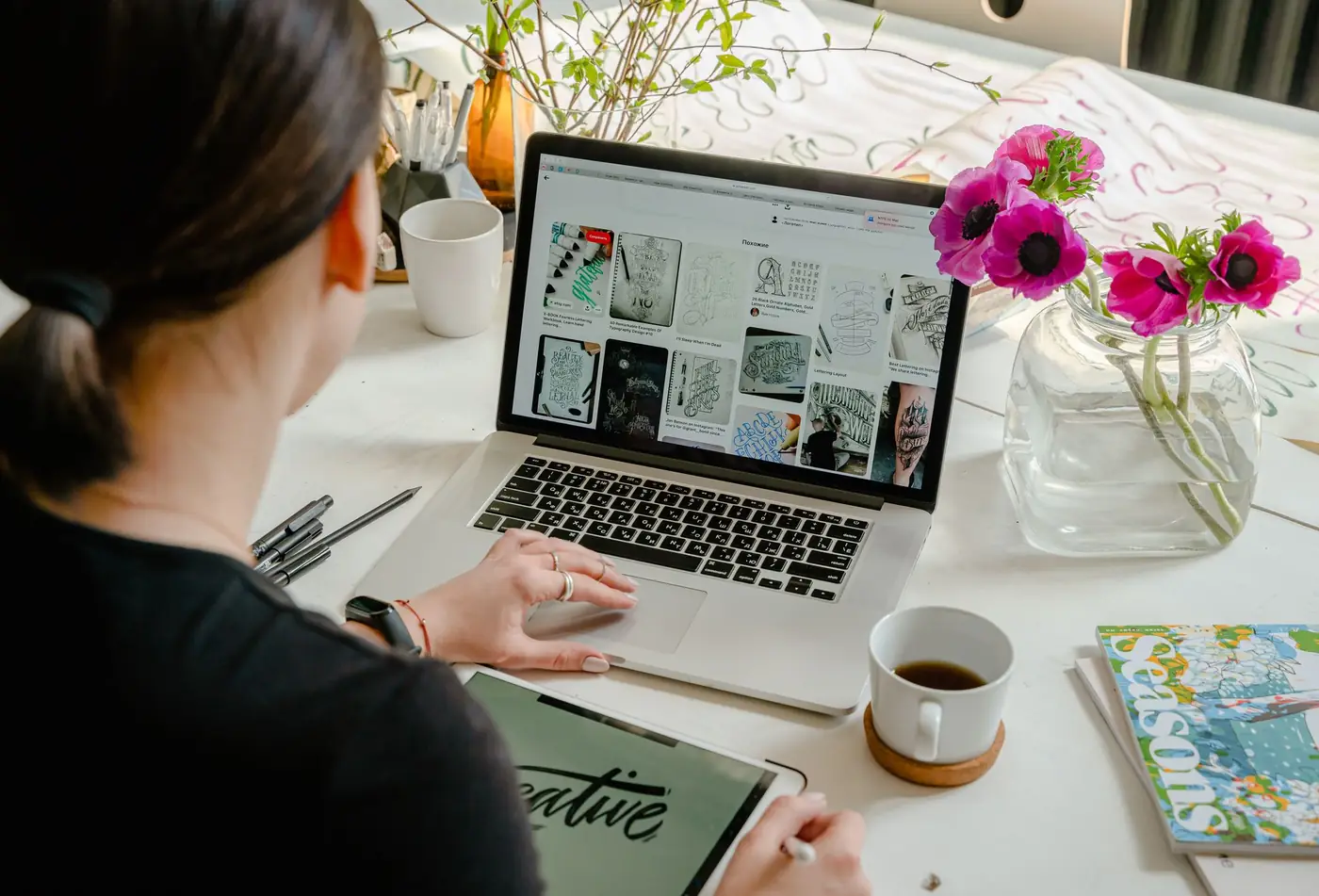 A designer working on layouts at a laptop